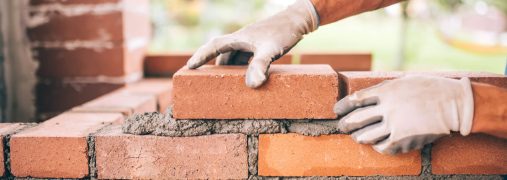 Professional,Construction,Worker,Laying,Bricks,And,Building,Barbecue,In,Industrial